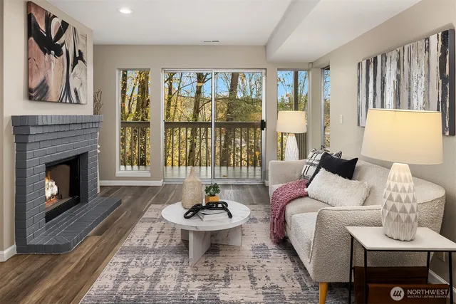 a living room with furniture a fireplace and a table
