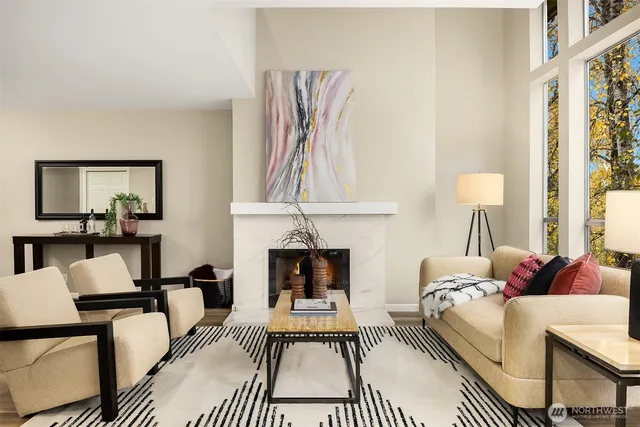 a living room with furniture a fireplace and a large mirror
