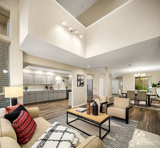 a living room with furniture and view of kitchen