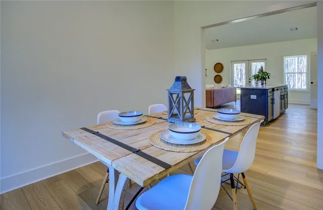 a dining room with furniture and wooden floor