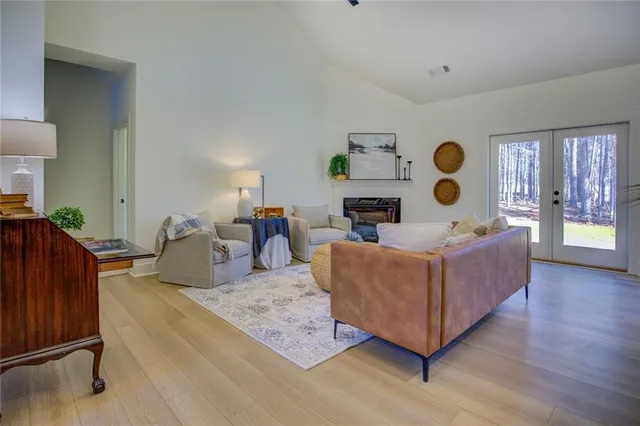 a living room with furniture and painting on the wall