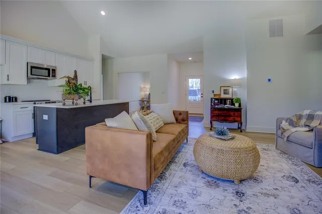 a living room with furniture and a potted plant