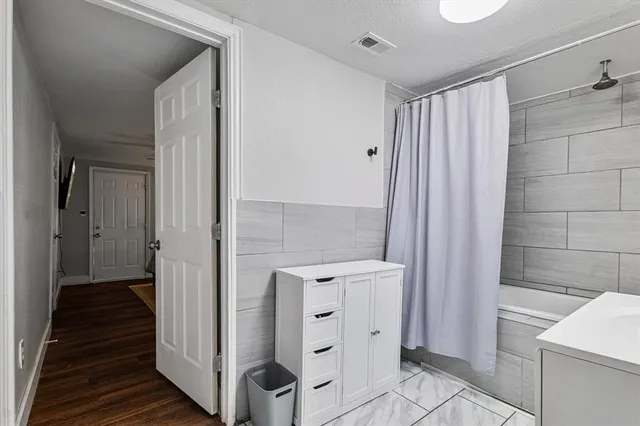 a bathroom with a sink mirror vanity and toilet