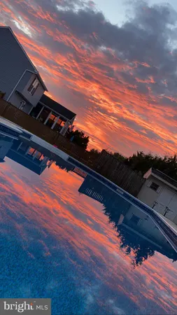 a view of swimming pool with outdoor seating