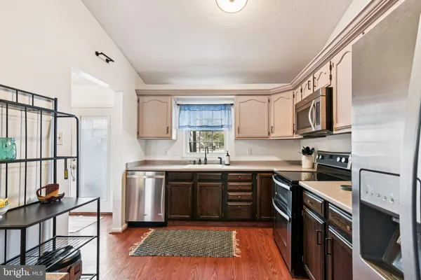 a kitchen with stainless steel appliances granite countertop a stove a sink dishwasher and a refrigerator