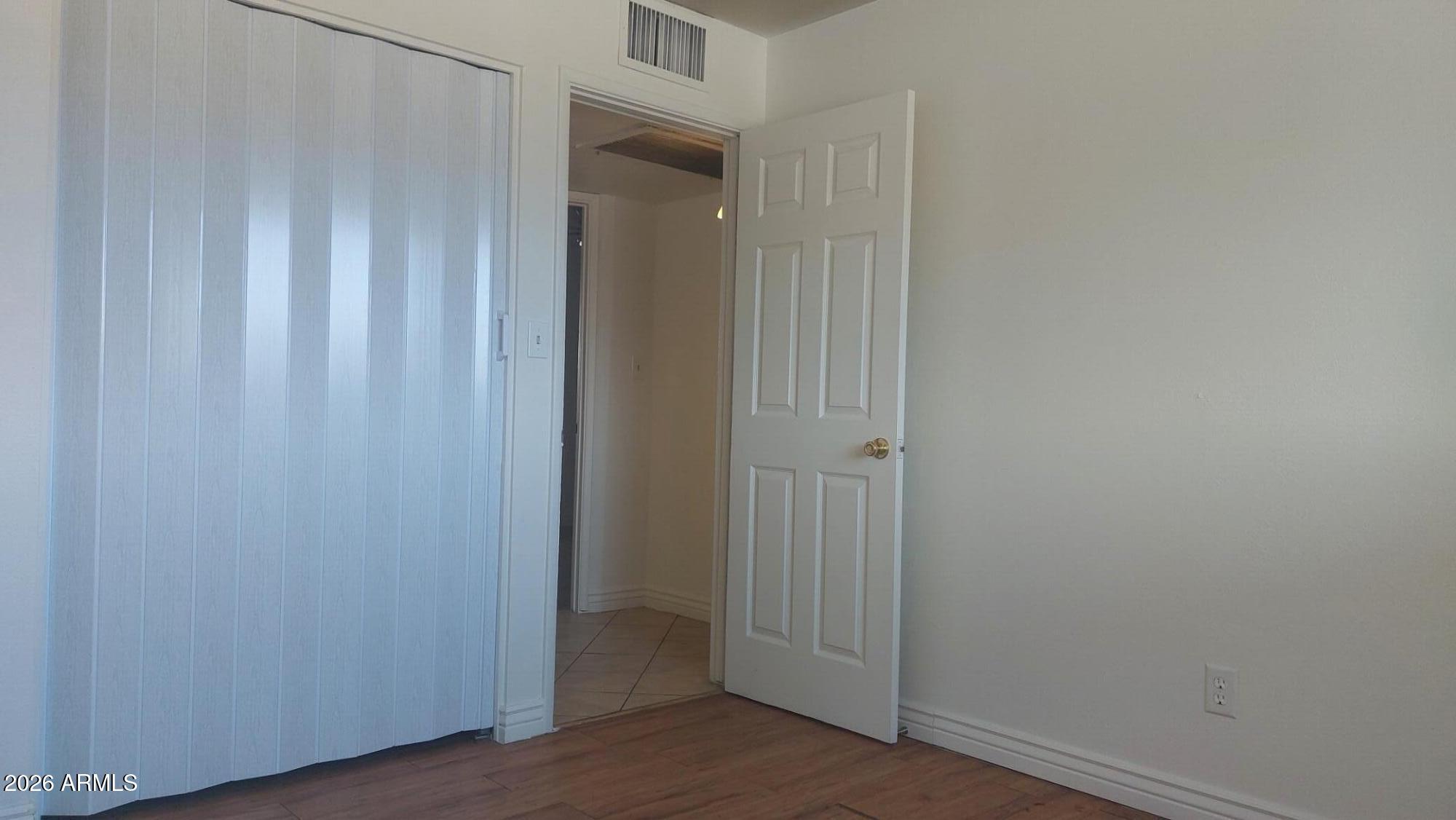2448 West Freeway Lane Phoenix, AZ 85021 - Photo 16 of 27 a view of a hallway with wooden floor