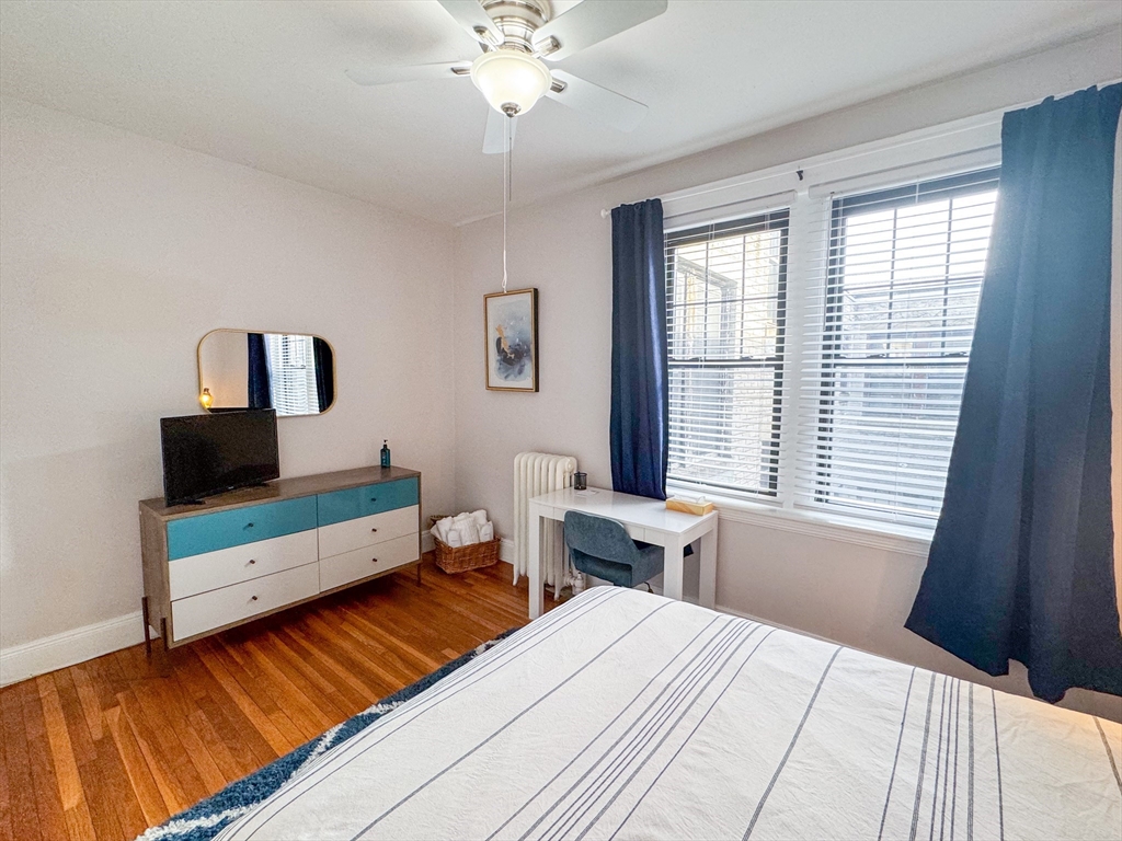 29 Mt Hood Road, Unit 12FURNISHED Boston, MA 02135 - Photo 7 of 11 a bedroom with a bed and a flat tv screen on the dresser