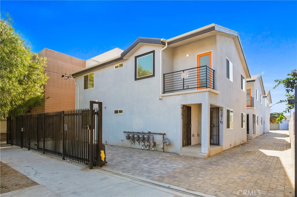 9241 1/2 Firth Boulevard, Unit 1/2 Los Angeles, CA 90002 - Photo 25 of 25 a front view of a house with glass windows and plants