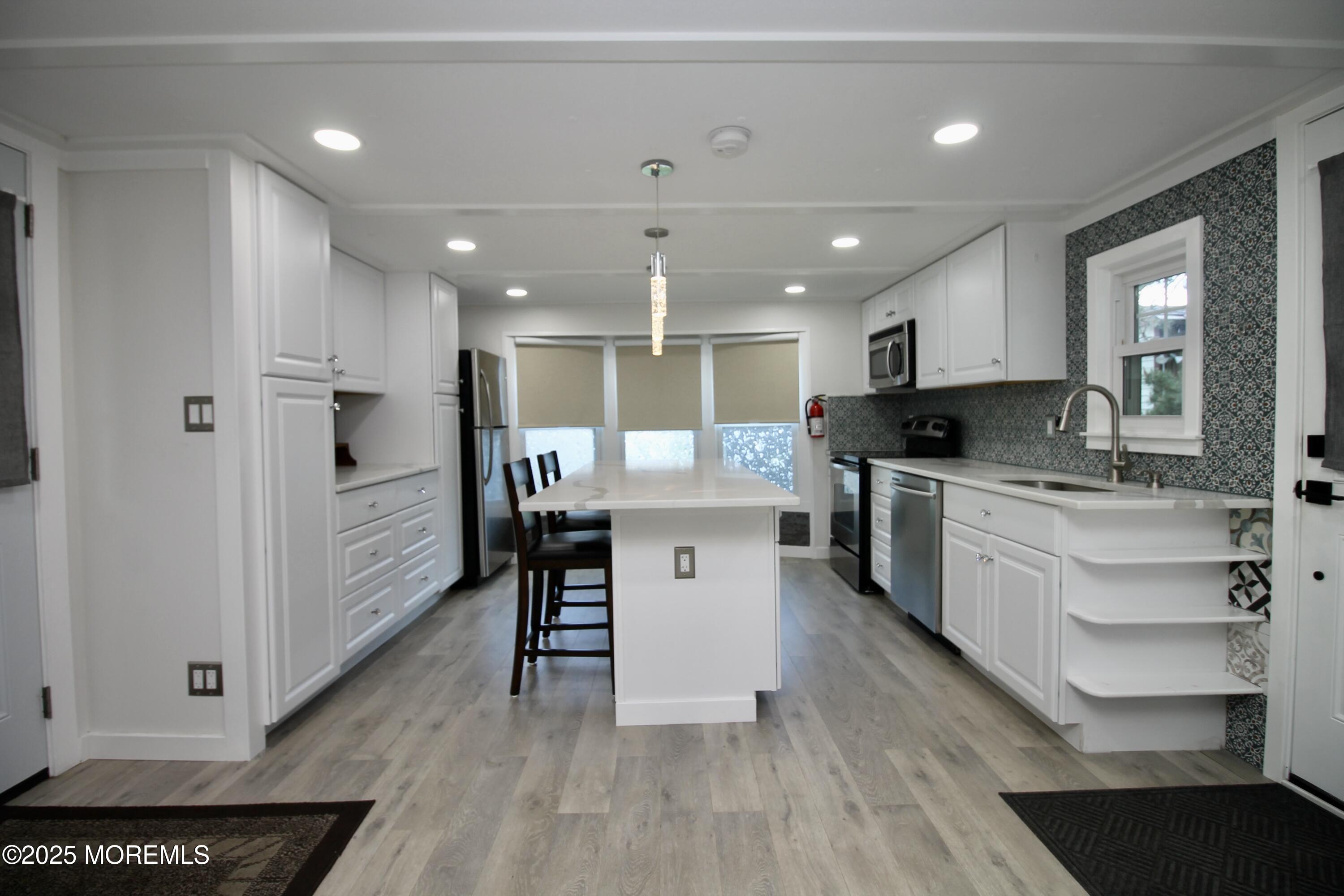 41 Eagle Drive Whiting, NJ 08759 - Photo 11 of 31 a large white kitchen with lots of counter space a sink appliances and cabinets