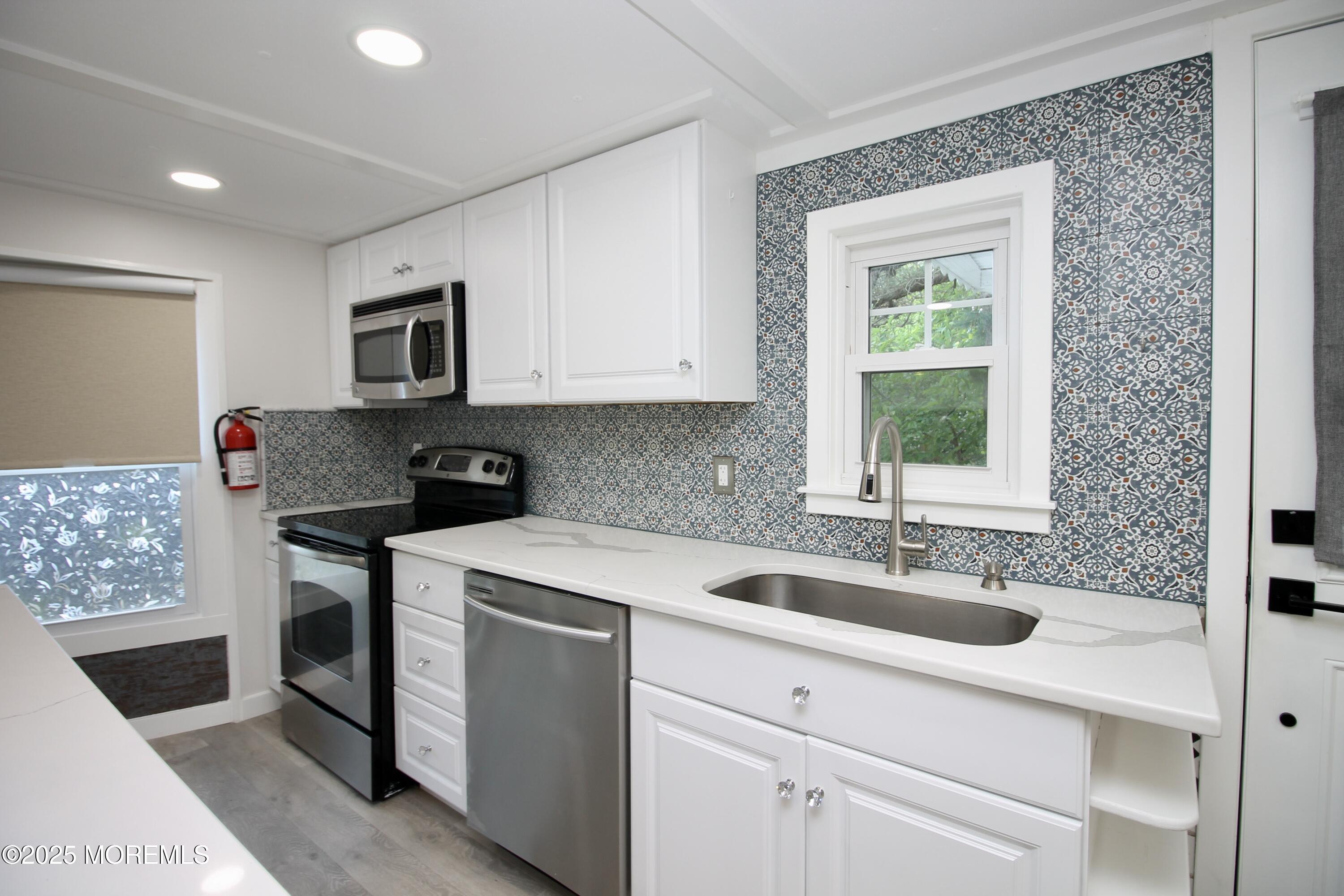 41 Eagle Drive Whiting, NJ 08759 - Photo 12 of 31 a kitchen with a sink stove and microwave