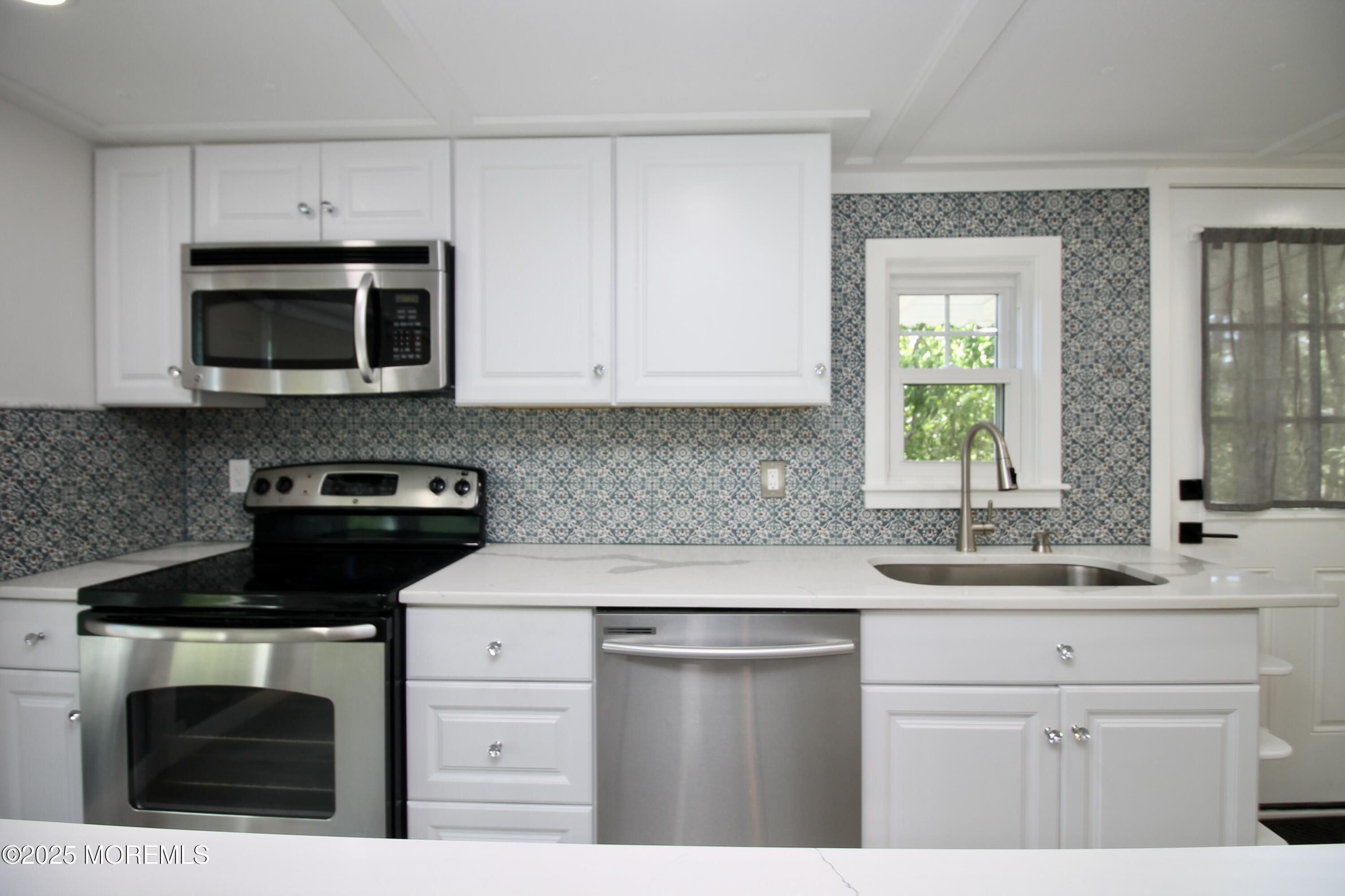 41 Eagle Drive Whiting, NJ 08759 - Photo 16 of 31 a kitchen with cabinets stainless steel appliances a sink and a stove