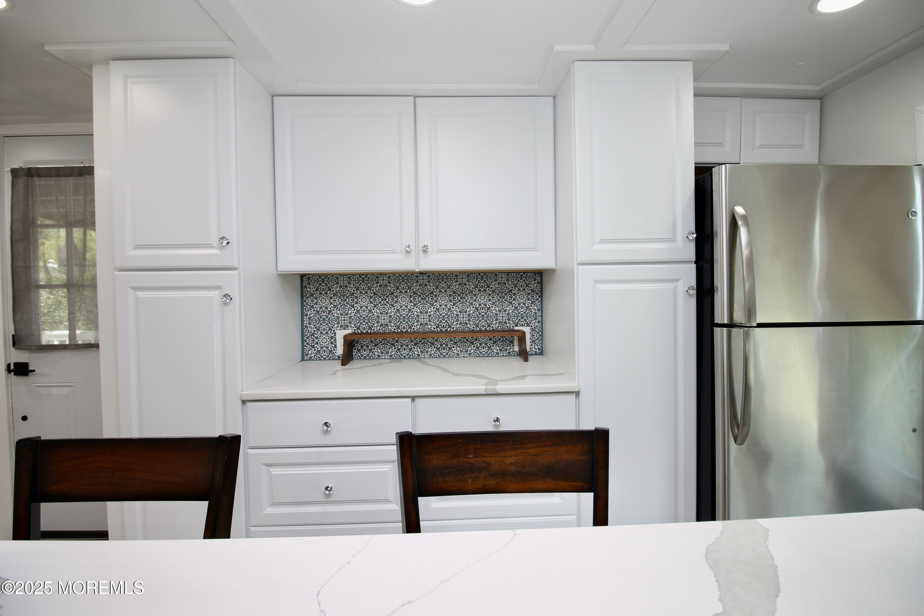 41 Eagle Drive Whiting, NJ 08759 - Photo 18 of 31 a kitchen with white cabinets and refrigerator