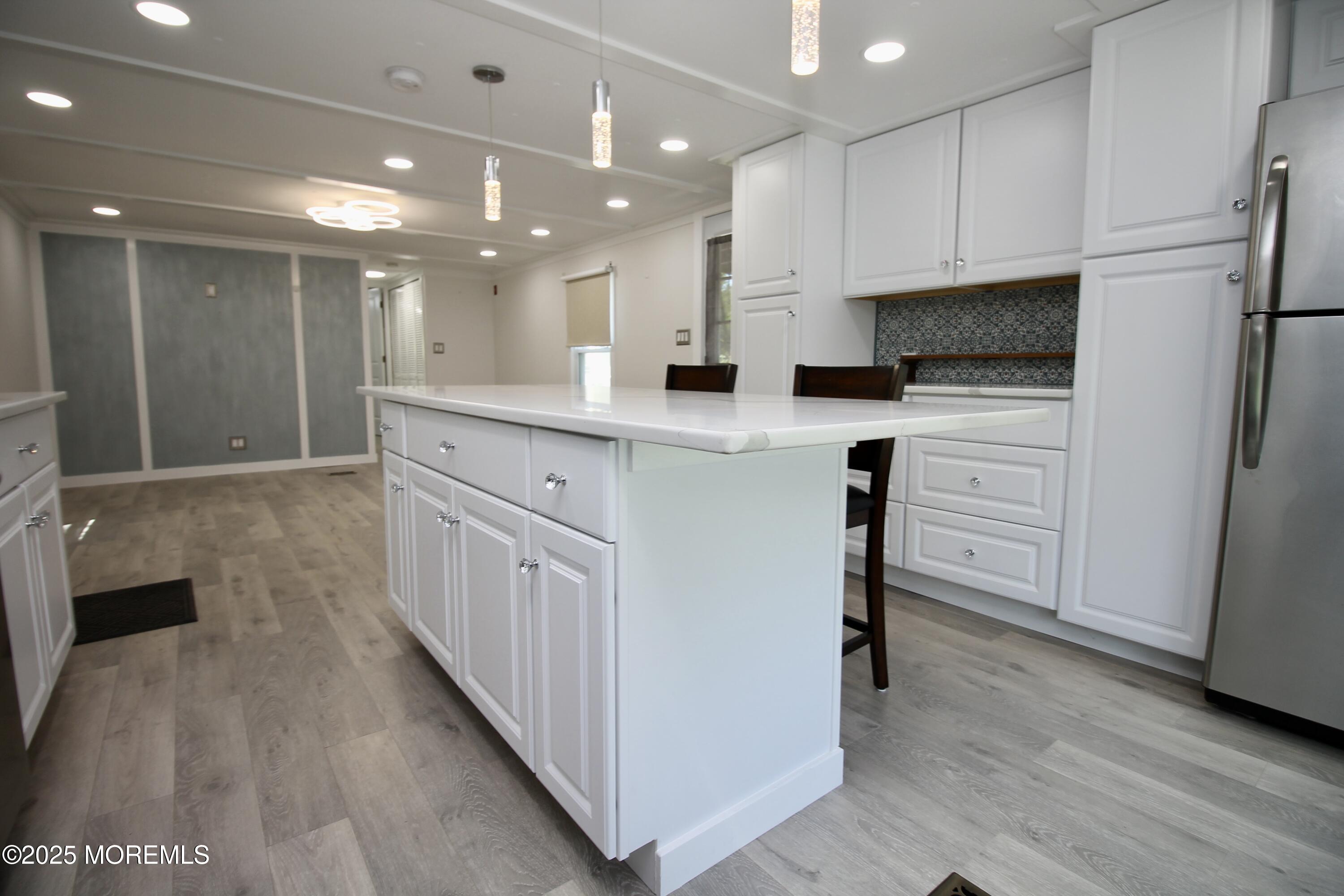 41 Eagle Drive Whiting, NJ 08759 - Photo 19 of 31 a kitchen with white cabinets and stainless steel appliances