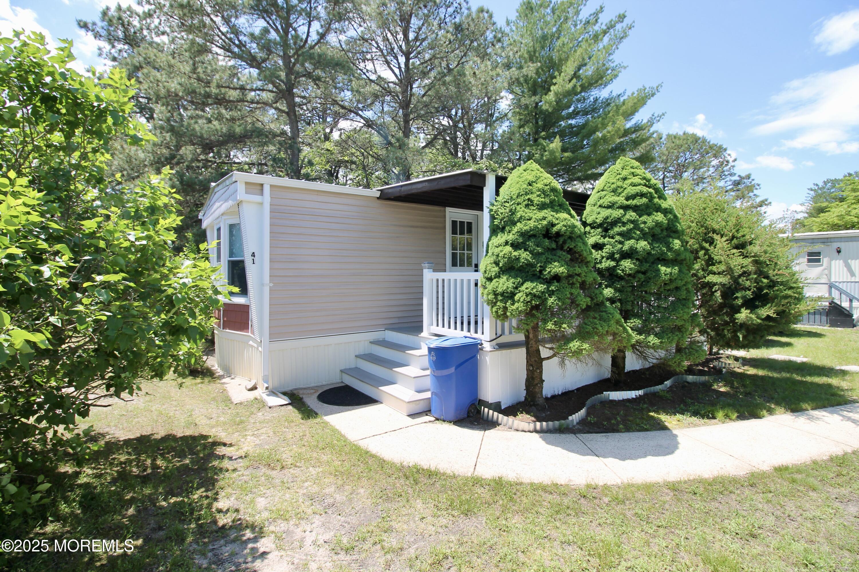 41 Eagle Drive Whiting, NJ 08759 - Photo 3 of 31 a wooden bench sitting in front of a house