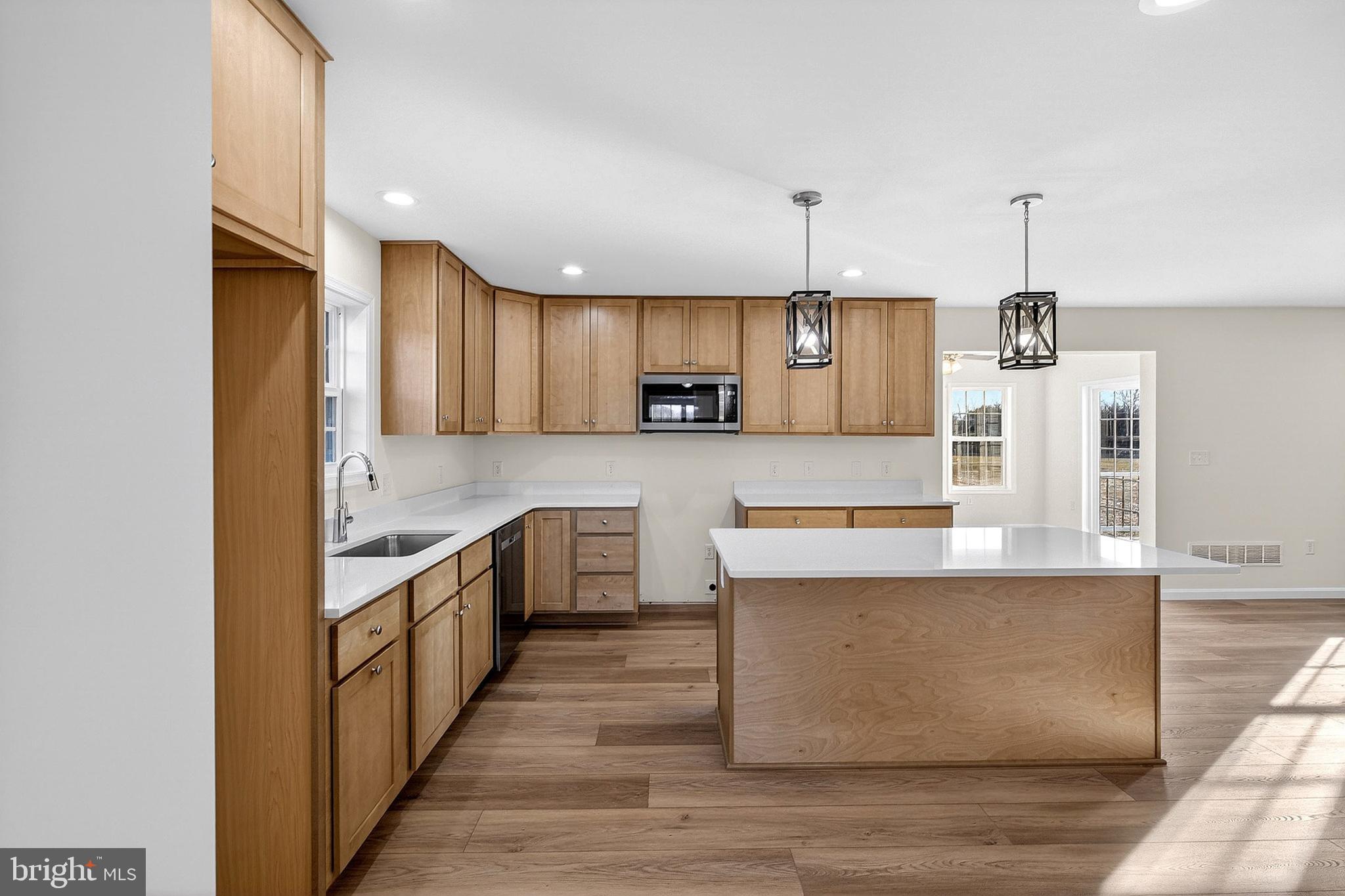 719 West Evens Road Viola, DE 19979 - Photo 11 of 65 a large kitchen with stainless steel appliances kitchen island granite countertop a stove and a sink