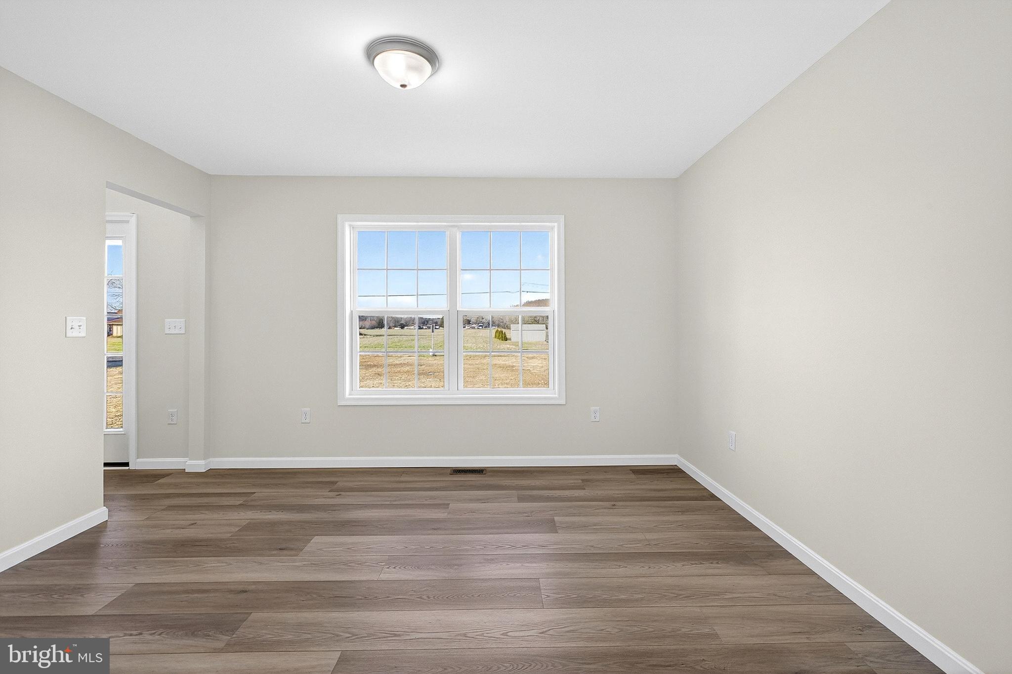 719 West Evens Road Viola, DE 19979 - Photo 16 of 65 a view of an empty room with wooden floor and a window