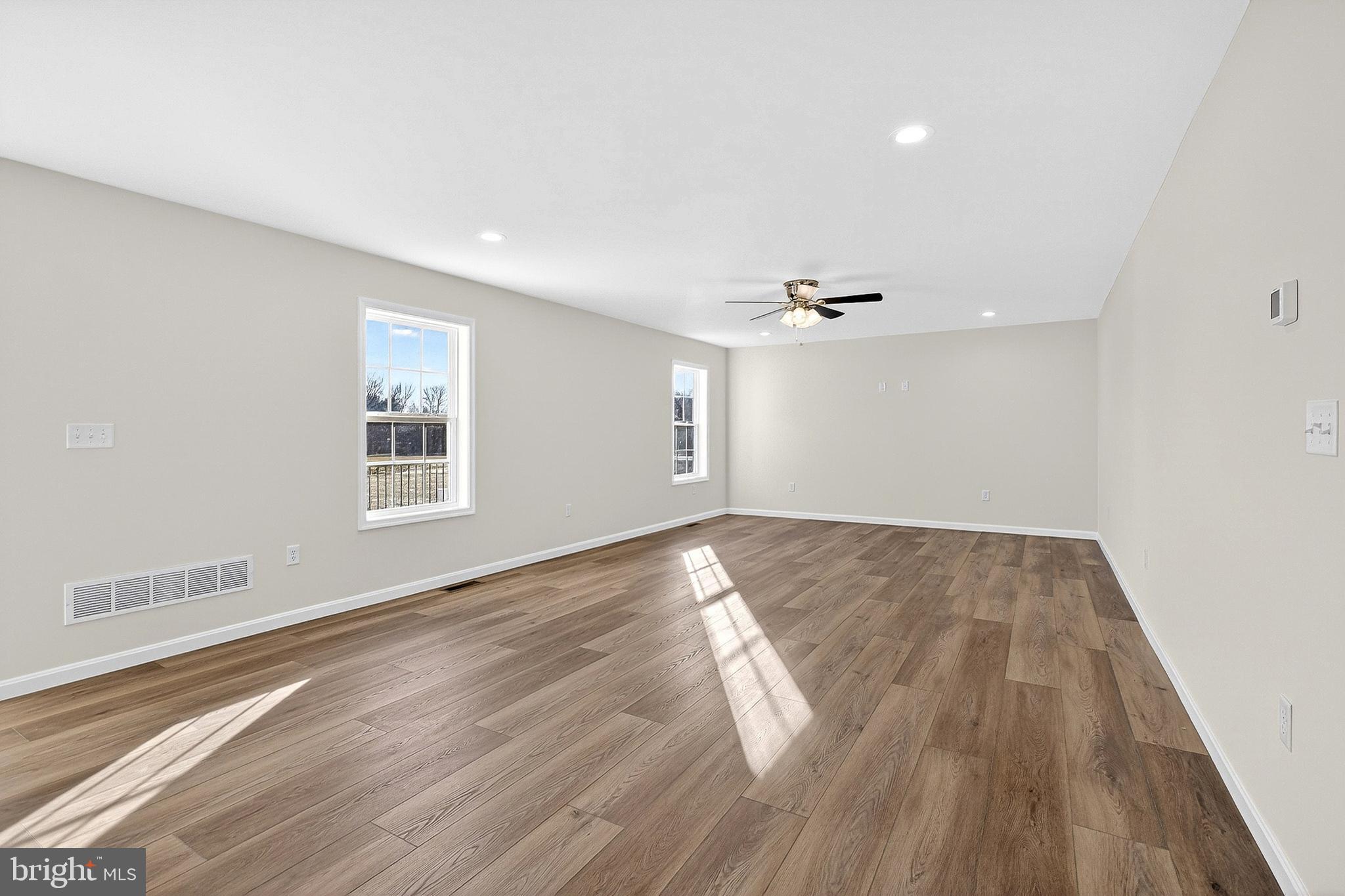 719 West Evens Road Viola, DE 19979 - Photo 20 of 65 an empty room with wooden floor and windows