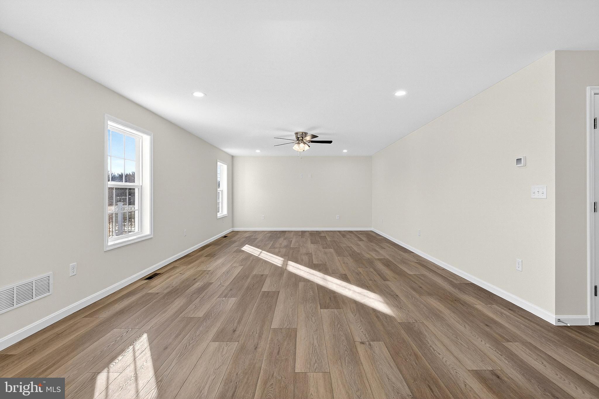 719 West Evens Road Viola, DE 19979 - Photo 21 of 65 an empty room with wooden floor and windows