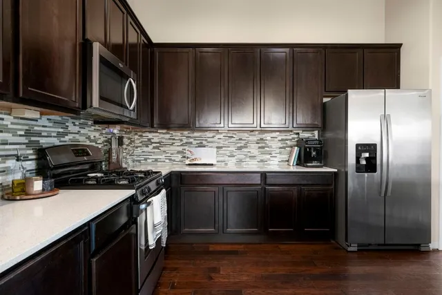 a kitchen with a sink stove and refrigerator