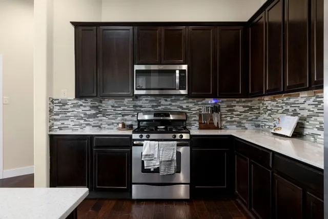 a kitchen with a sink stove and microwave