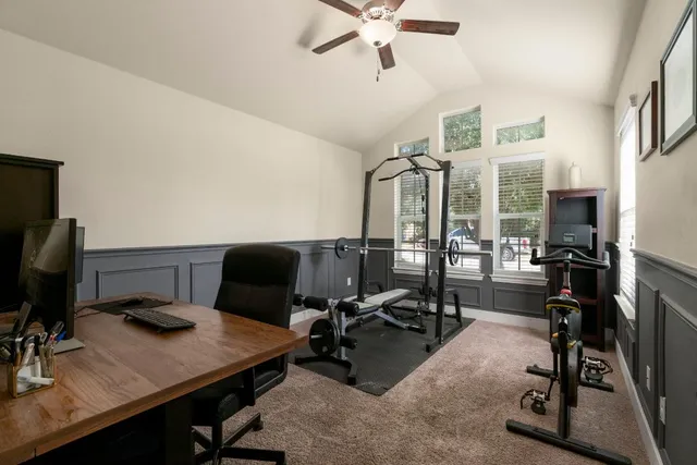 a view of a workspace with furniture and a flat screen tv