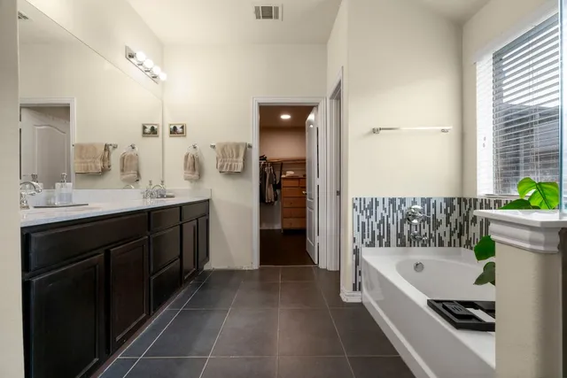 a bathroom with a bathtub and a sink