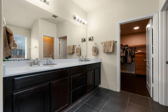 a bathroom with a double vanity sink and a mirror