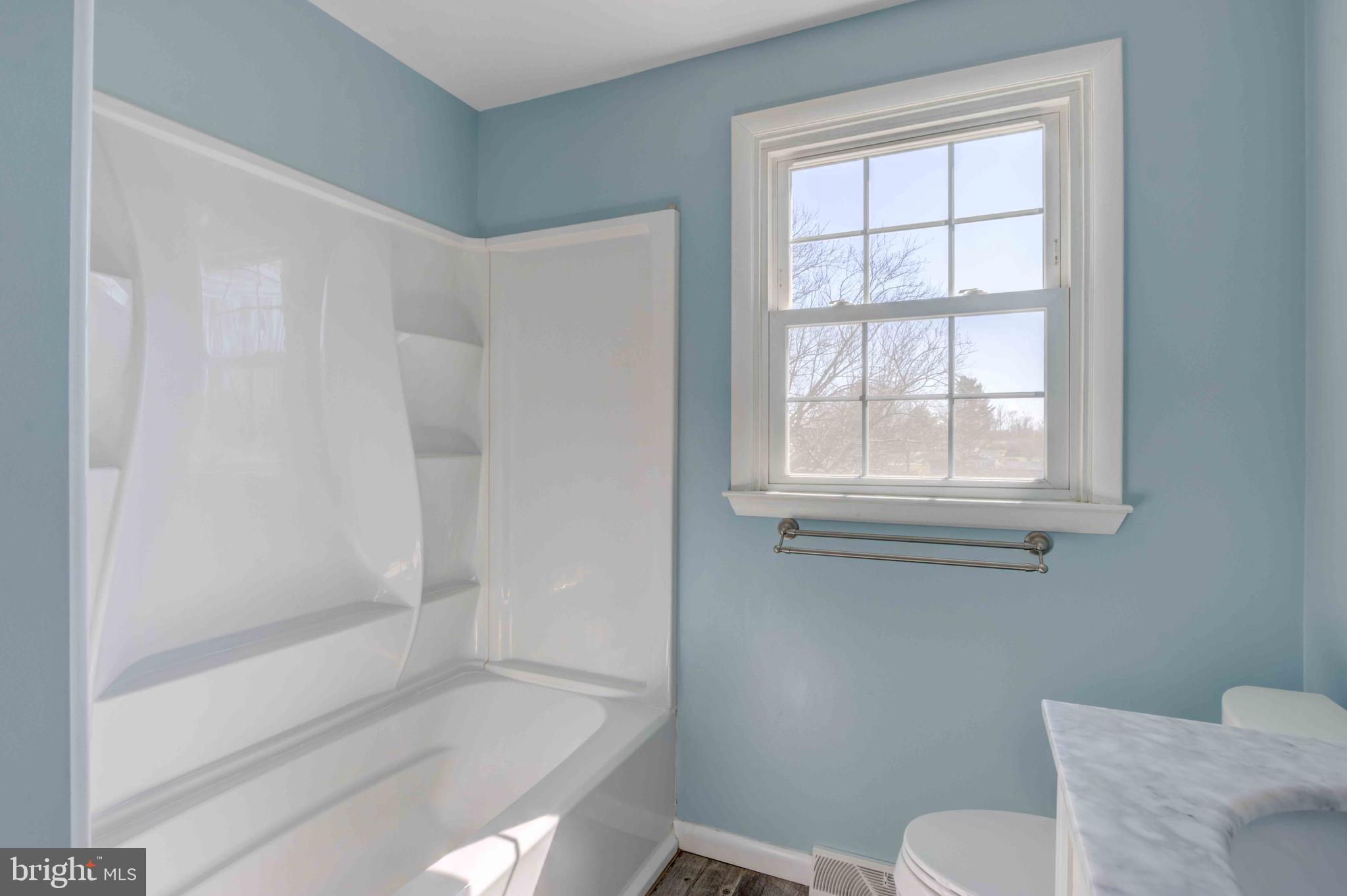 1911 Suffolk Road Finksburg, MD 21048 - Photo 25 of 43 a bathroom with a granite countertop bathtub next to a window