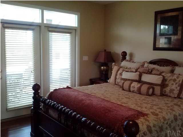 1498 Chemstrand Road Cantonment, FL 32533 - Photo 20 of 23 LARGE MASTER BEDROOM WITH HARDWOOD FLOORS, AND FRENCH DOORS THAT LEAD TO PORCH AND POOL AREA