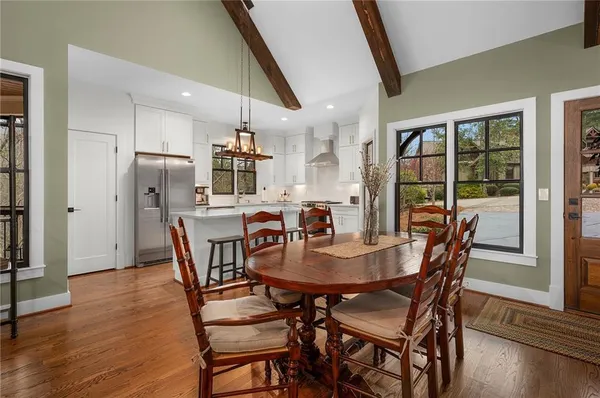 a open kitchen with stainless steel appliances granite countertop a stove and a sink with wooden floor