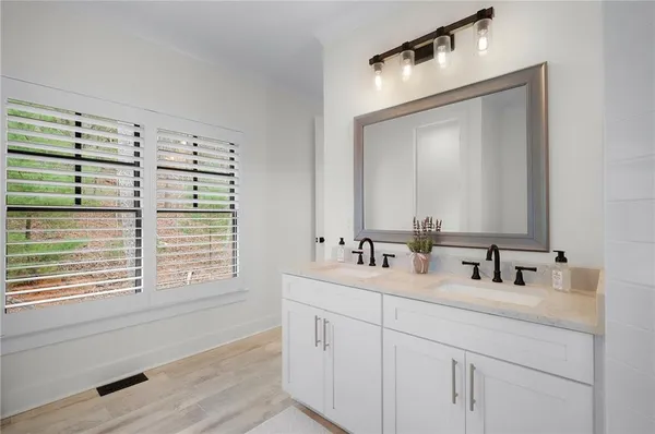 a view of an apartment with wooden floor and a ceiling fan