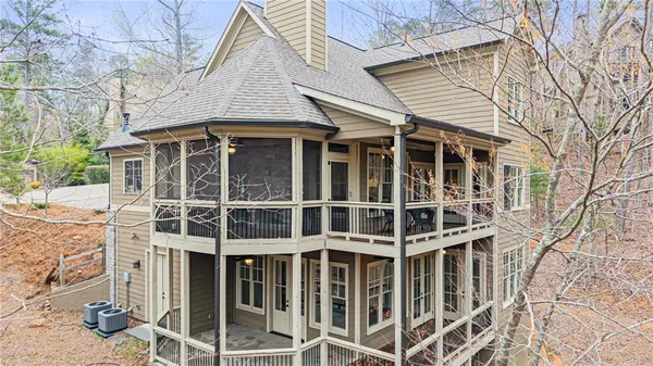 a living room with furniture and floor to ceiling windows