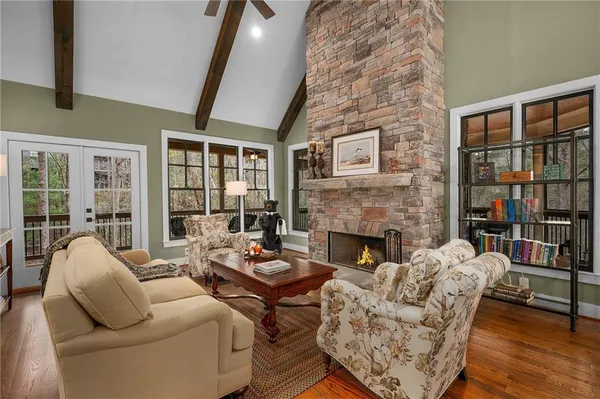 a living room with furniture wooden floor and a large window