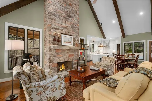 a living room with fireplace furniture and a wooden floor