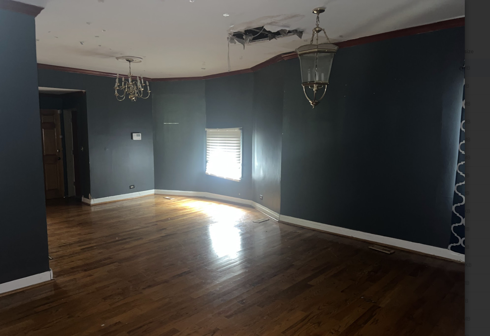 11745 South Wallace Street Chicago, IL 60628 - Photo 2 of 13 an empty room with wooden floor and windows