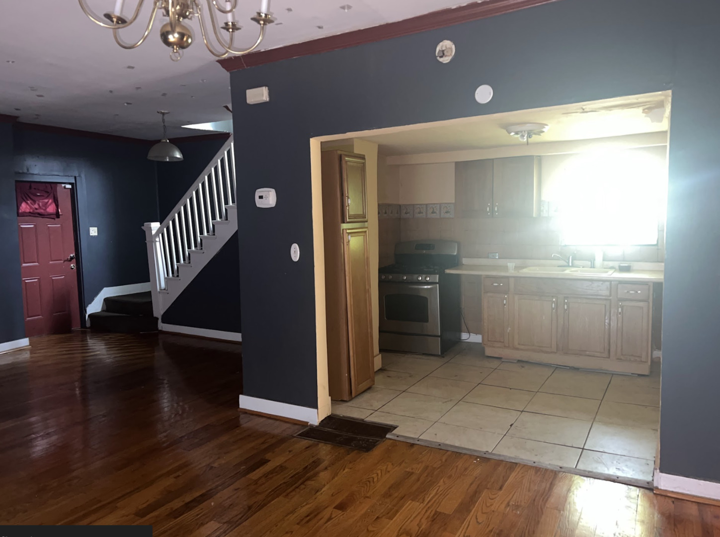 11745 South Wallace Street Chicago, IL 60628 - Photo 4 of 13 a view of entryway with stairs and wooden floor