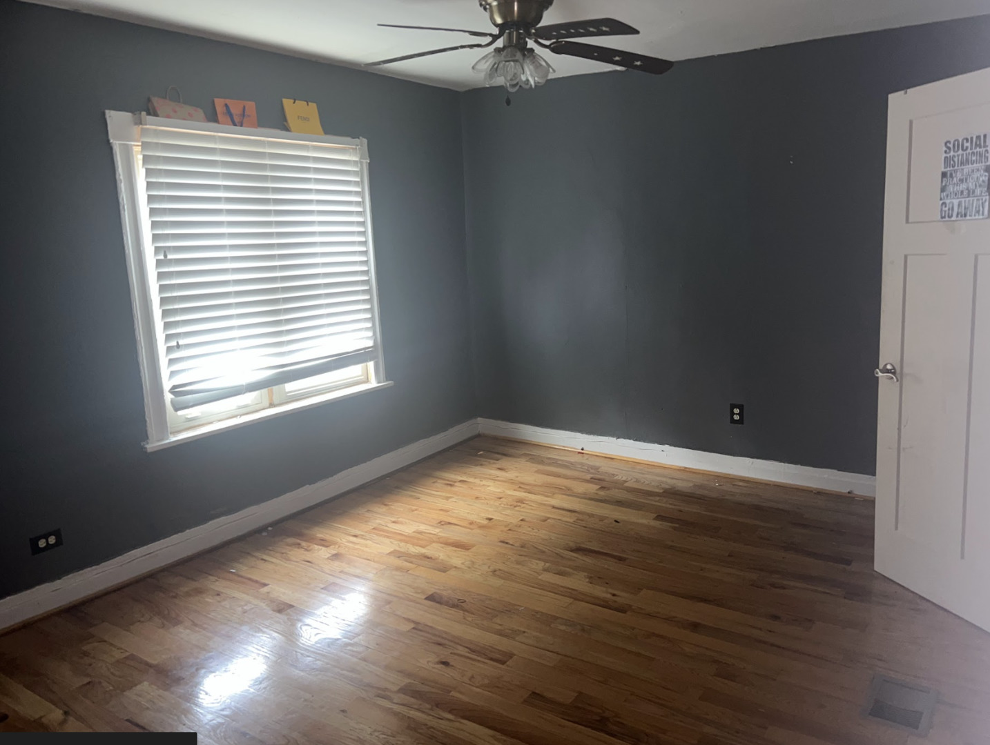 11745 South Wallace Street Chicago, IL 60628 - Photo 9 of 13 a view of an empty room with wooden floor and a window