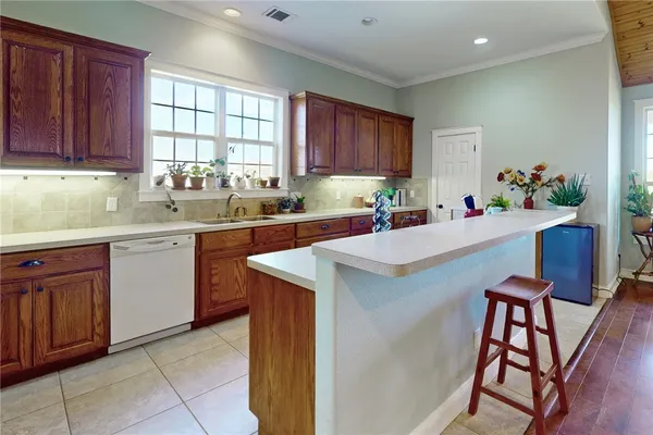 a kitchen with a sink cabinets and window