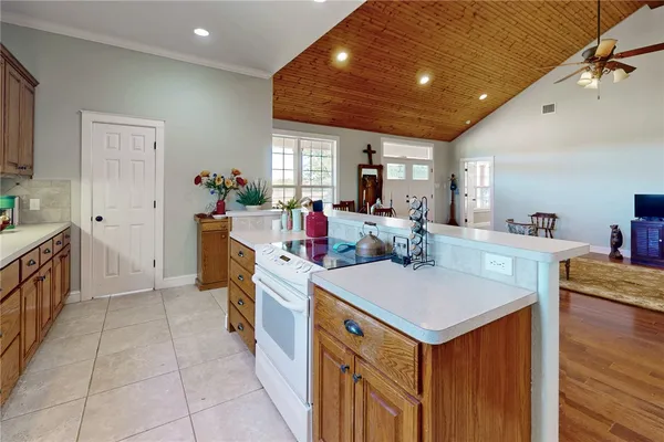 a view of kitchen with kitchen island a sink a stove and a refrigerator