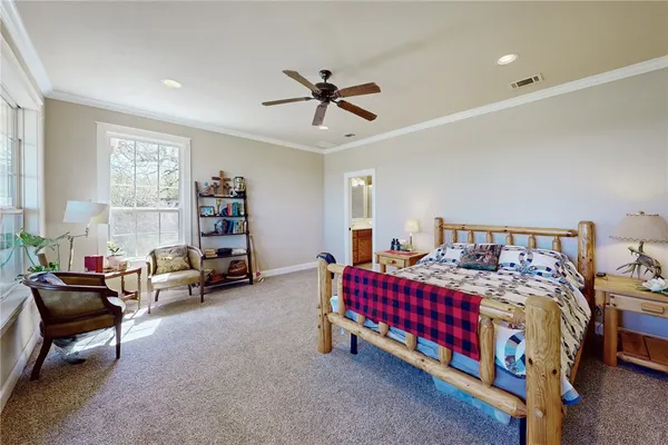 a bedroom with bed and a chandelier