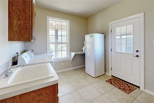 a kitchen with a sink cabinets and utility
