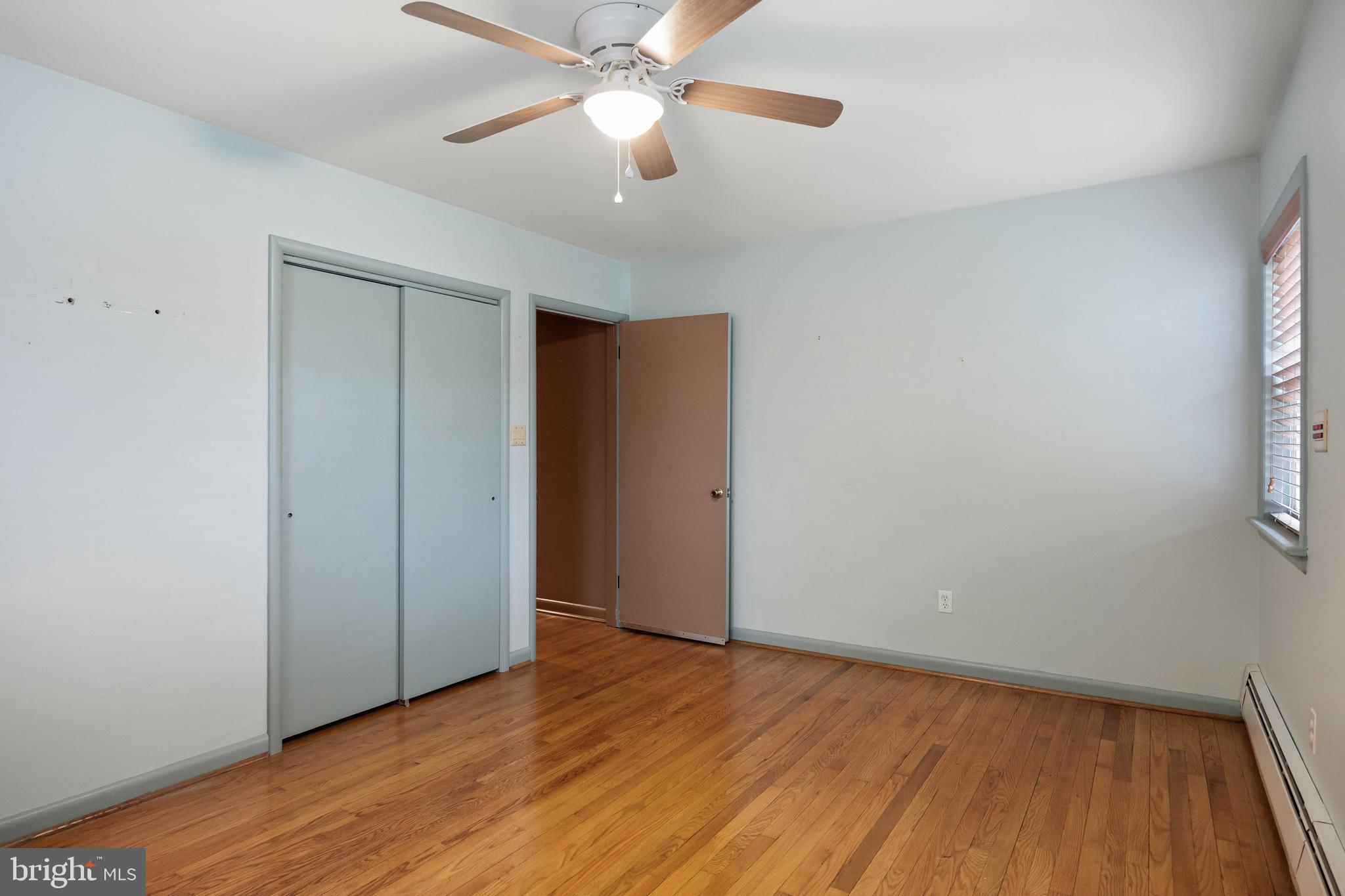55 East Evesham Road Runnemede, NJ 08078 - Photo 13 of 26 an empty room with wooden floor fan and windows