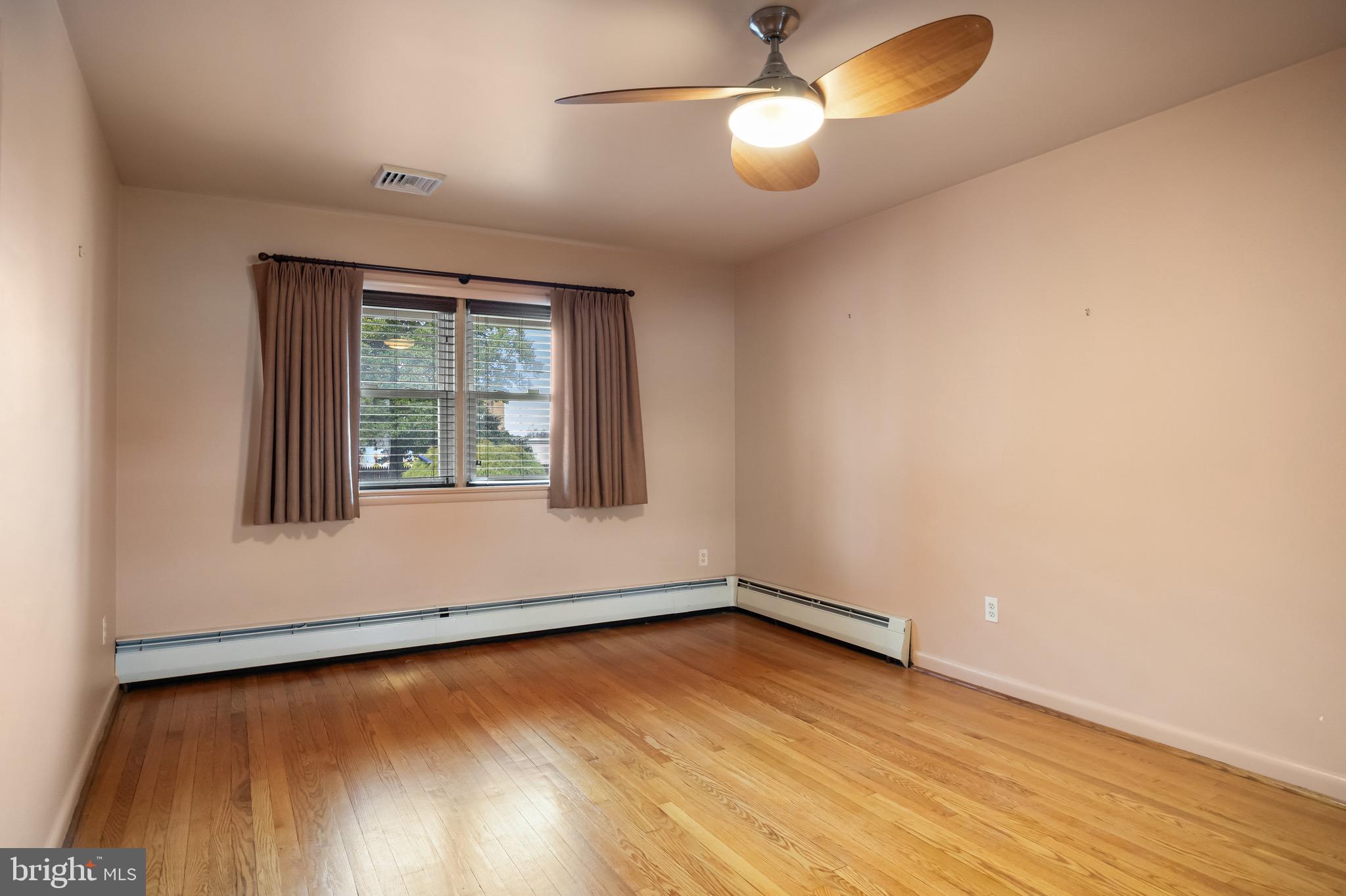 55 East Evesham Road Runnemede, NJ 08078 - Photo 17 of 26 an empty room with wooden floor and windows