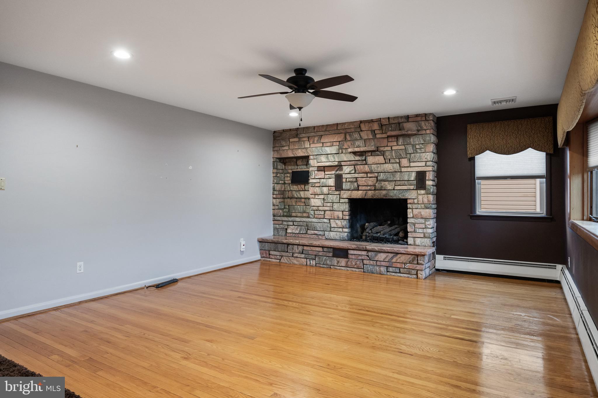 55 East Evesham Road Runnemede, NJ 08078 - Photo 4 of 26 an empty room with fireplace and windows