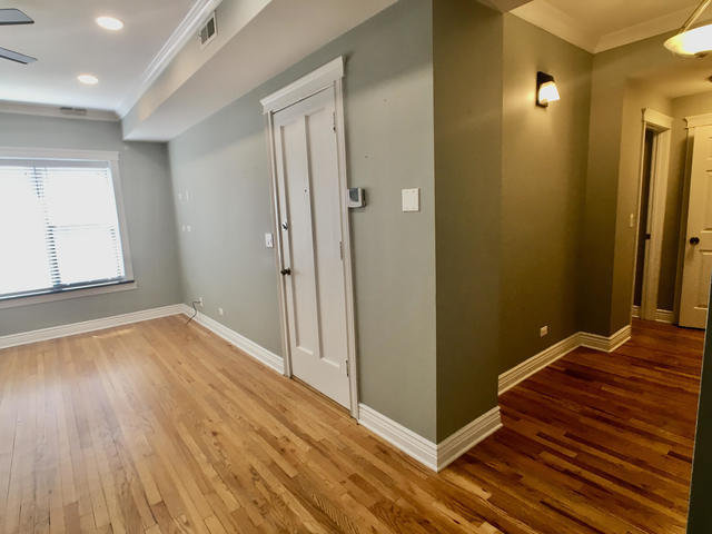 5934 North Paulina Street, Unit 2 Chicago, IL 60660 - Photo 4 of 12 a view of a hallway with wooden floor and a bathroom