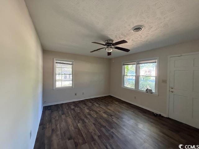 1909 9th Avenue Conway, SC 29527 - Photo 2 of 15 Unfurnished room featuring dark wood-type flooring, a textured ceiling, and a ceiling fan