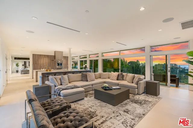 a living room with furniture city view and large windows
