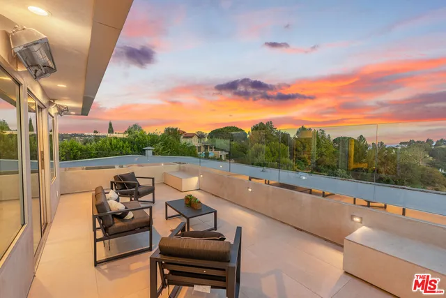 a view of a terrace with couches and sky view