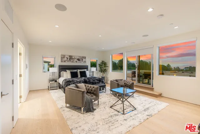 a living room with furniture a fireplace and a large window