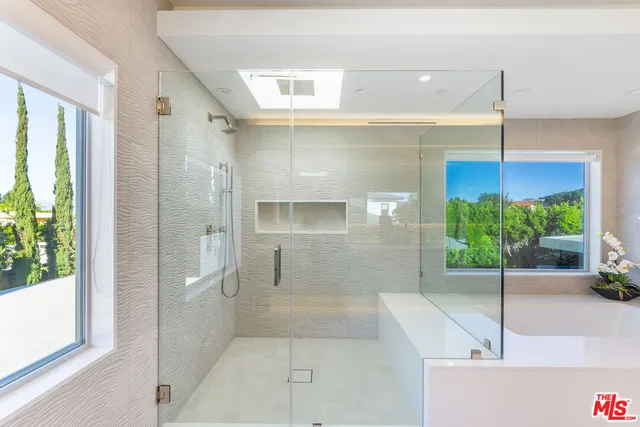 a bathroom with a shower and a sink